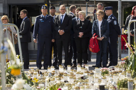 The Chief of Turku Police Tapio Huttunen, Finland's Prime Minister Juha Sipila and Finnish parliament member Annika Saarikko stand next to the memorial flowers at the Turku Market Square, in Turku, Finland, August 21, 2017. Lehtikuva/Roni Lehti via REUTERS ATTENTION EDITORS - THIS IMAGE WAS PROVIDED BY A THIRD PARTY. NO THIRD PARTY SALES. NOT FOR USE BY REUTERS THIRD PARTY DISTRIBUTORS. FINLAND OUT. NO COMMERCIAL OR EDITORIAL SALES IN FINLAND.