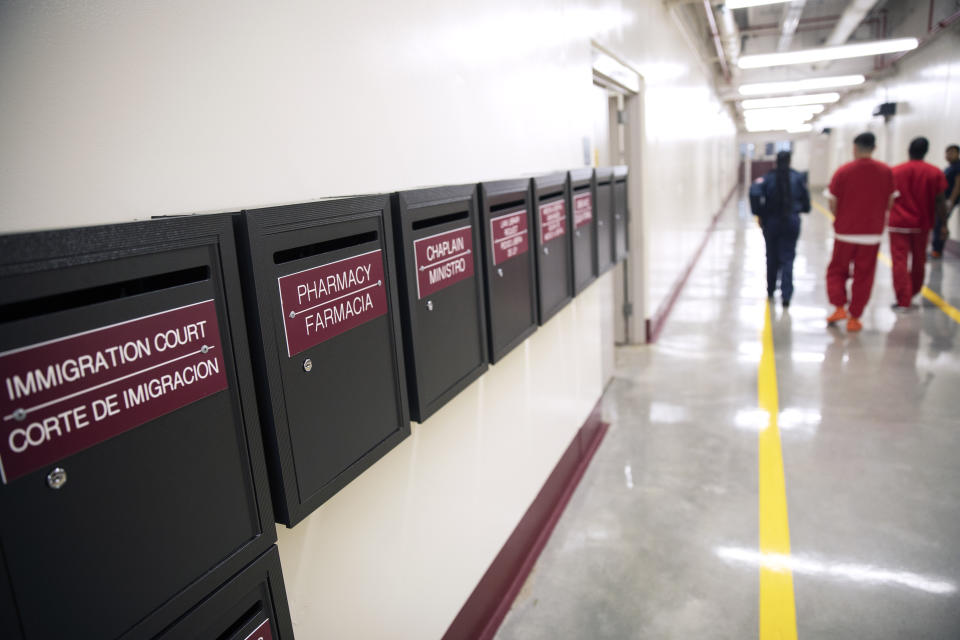 Mail boxes for various departments line a hallway as detainees walk through the Stewart Detention Center, Friday, Nov. 15, 2019, in Lumpkin, Ga. The rural town is about 140 miles southwest of Atlanta and next to the Georgia-Alabama state line. The town’s 1,172 residents are outnumbered by the roughly 1,650 male detainees that U.S. Immigration and Customs Enforcement said were being held in the detention center in late November. (AP Photo/David Goldman)