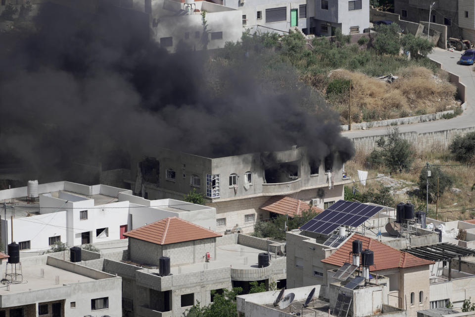 Smoke rises from a home during an Israeli military operation in the West Bank town of Jenin, Friday, May 13, 2022. Israeli troops pushed into Jenin early Friday following the death of veteran Al Jazeera correspondent Shireen Abu Akleh on Wednesday when she was shot dead by Israeli forces while covering a military operation in the occupied West Bank. (AP Photo/Majdi Mohammed)