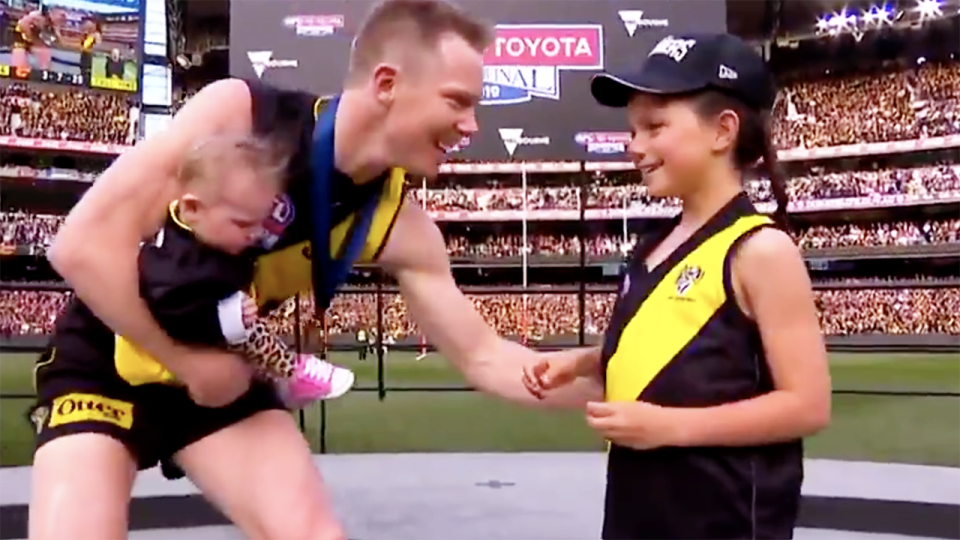 The young girl, pictured here giving the medal to Jack Riewoldt.