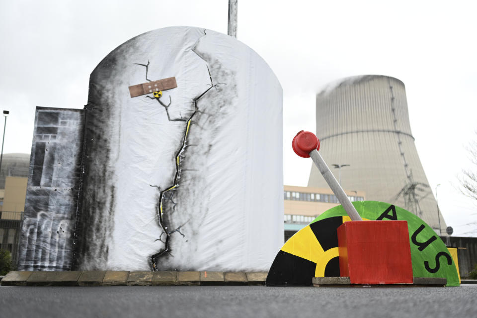 A mock lever to shut down the Emsland nuclear power plant is pictured in front of the power plant in , Lingen, Germany, Saturday, April 15, 2023. Germany is shutting down the last three nuclear power plants today as a part of an energy transition agreed by successive governments. Word reads 'off.' (Lars Klemmer/dpa via AP)