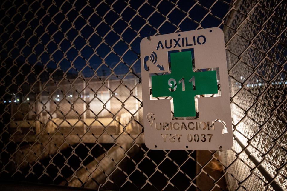 An auxilio sign with a number to indicate its precise location is written in Spanish near a water gate on the main canal just north of the border wall in the lower valley in June 2023. "In years past, we would go to Juárez and hand out fliers in Spanish ... to make sure they are well aware of the dangers," said Robert Rios, water master.