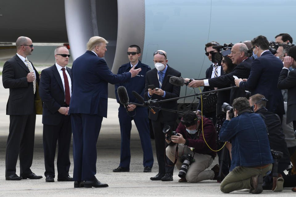 President Donald Trump talks with members of the traveling press before departing Andrews Air Force Base in Md., Tuesday, May 5, 2020. Trump is heading to Arizona and is expected to tour Honeywell International's mask-making operation in Phoenix. (AP Photo/Susan Walsh)