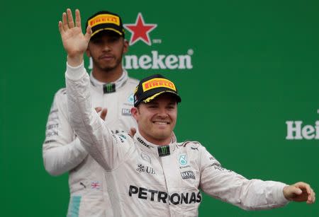 Formula One - F1 - Italian Grand Prix 2016 - Autodromo Nazionale Monza, Monza, Italy - 4/9/16 Mercedes' Nico Rosberg celebrates his win on the podium after the race as Lewis Hamilton looks on Reuters / Max Rossi Livepic