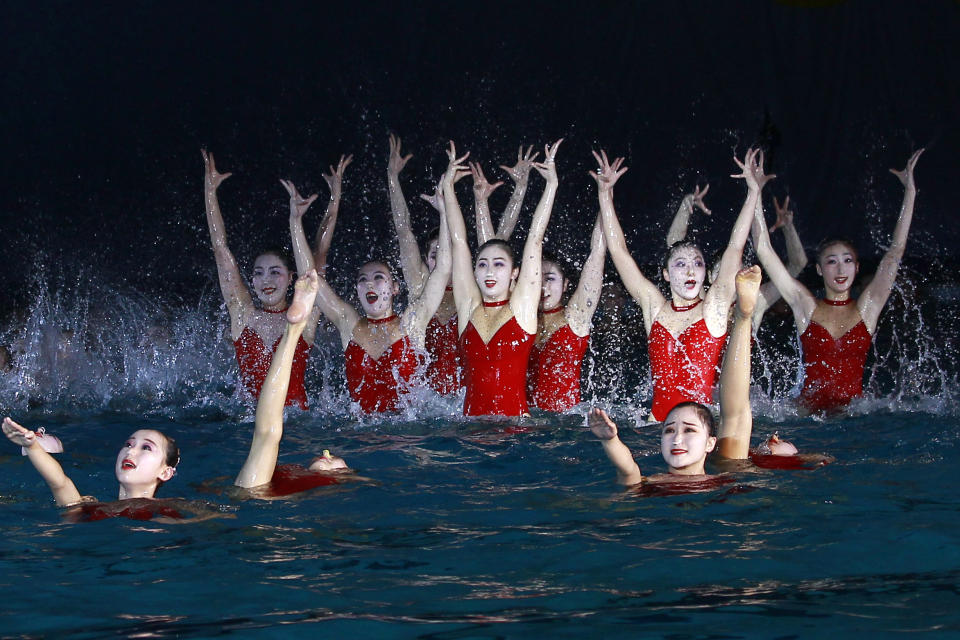 A group of synchronized swimmers perform celebrating the Day of Shining Star on the occasion of the 80th birth anniversary of former North Korean leader Kim Jong Il at the swimming gymnasium in Pyongyang, North Korea, Sunday, Feb. 13, 2022. (AP Photo/Cha Song Ho)