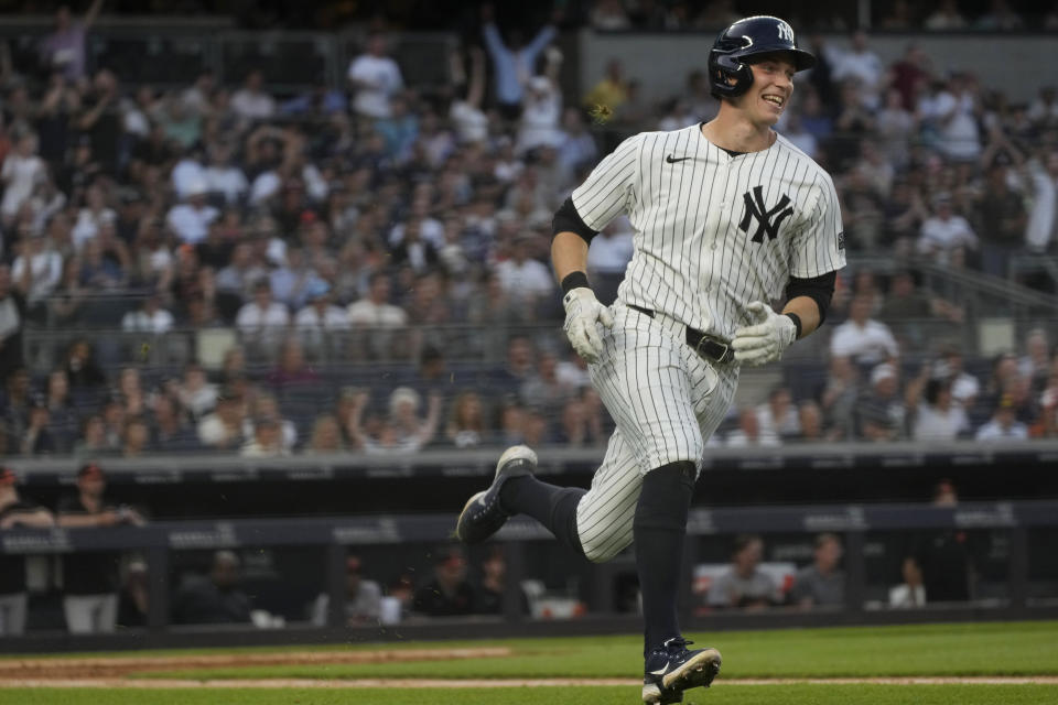 New York Yankees' Ben Rice smiles as he runs to first base after hitting a single during the third inning of the team's baseball game against the Baltimore Orioles, Tuesday, June 18, 2024, in New York. (AP Photo/Pamela Smith)