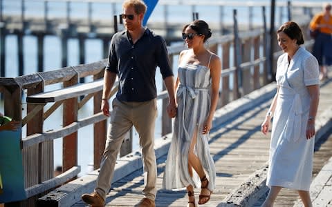 The Duke and Duchess walk hand-in-hand along the jetty - Credit: PHIL NOBLE /Reuters