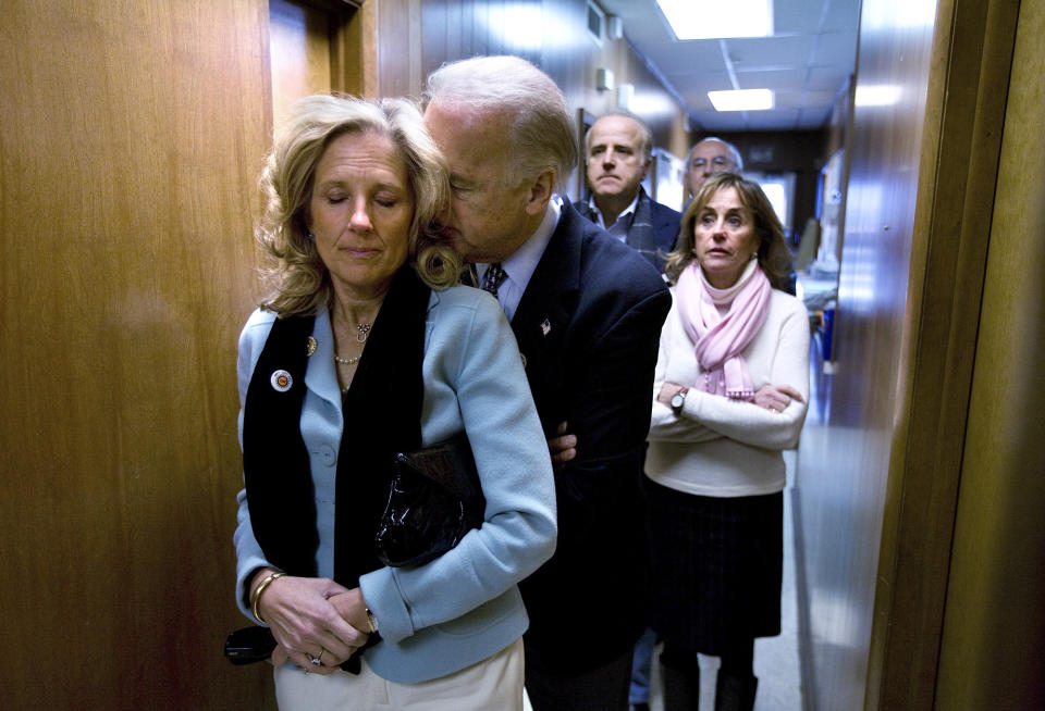 Democratic presidential hopeful, Sen. Joe Biden, D-Del., rests his head on the shoulder of his wife, Jill, as they stand in a hallway awaiting his introduction for a rally at the UAW Hall in Dubuque, Iowa, on the day of the Iowa caucus Thursday, Jan. 3, 2008. (AP Photo/Mark Hirsch)