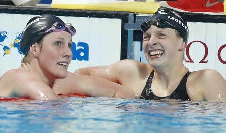 Missy Franklin of the U.S talks with her compatriot Katie Ledecky (R) after the women's 200m freestyle semi-final at the Aquatics World Championships in Kazan, Russia, August 4, 2015. REUTERS/Hannibal Hanschke