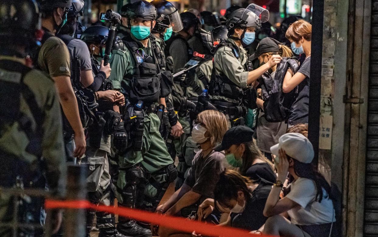 Riot police detain a group of people during a demonstration in Mongkok district in Hong Kong - Anthony Kwan/Getty Images