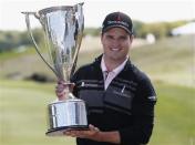 Zach Johnson of the U.S. poses with the trophy after winning the BMW Championship golf tournament at the Conway Farms Golf Club in Lake Forest, Illinois, September 16, 2013. REUTERS/Jim Young