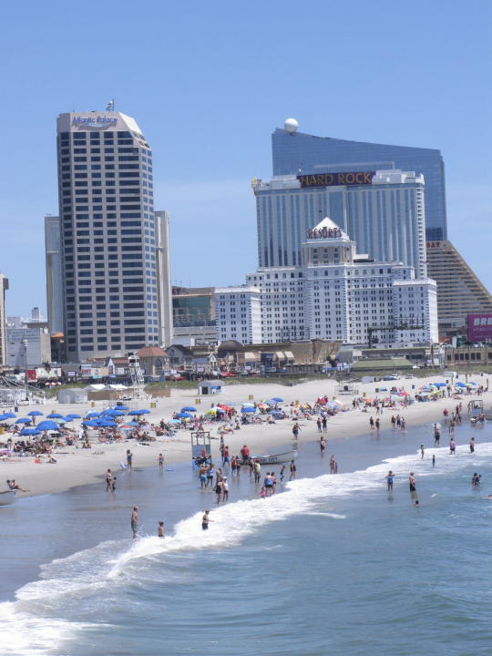 People take in the beach at the Atlantic City, N.J., beachfront on July 9, 2018. In a move made without public announcement or debate, a state Assembly panel on Tuesday, June 27, 2023, amended a bill that would have extended New Jersey's internet gambling law for another 10 years. shortening that time frame to just two years. (AP Photo/Wayne Parry)