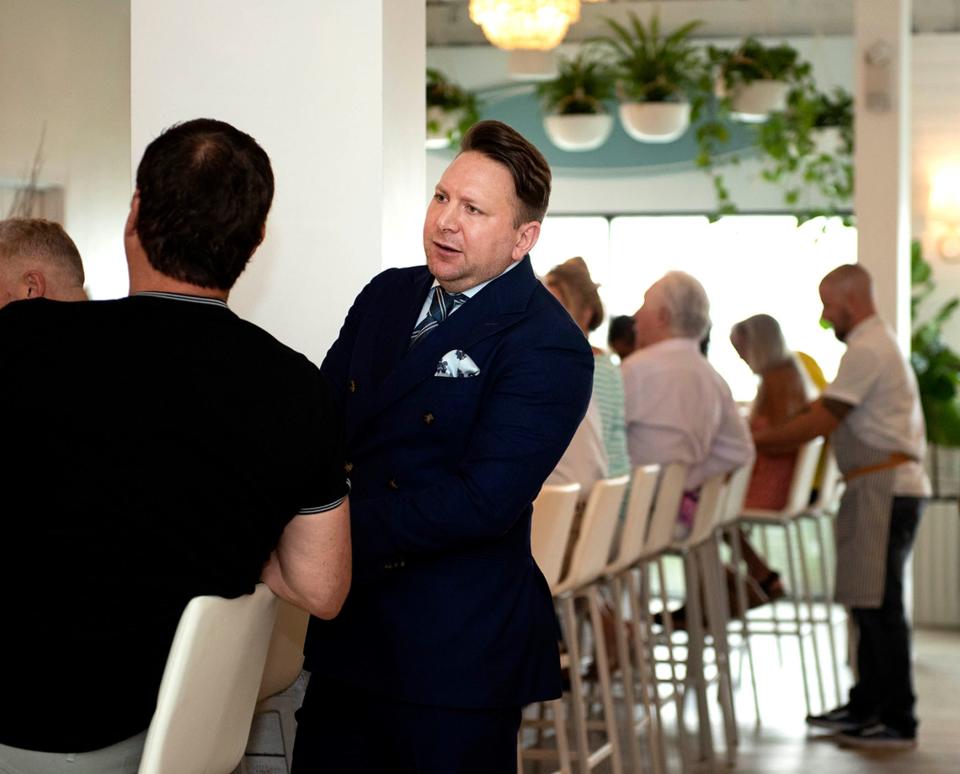 Restaurateur and hospitality consultant Stephen Asprinio chats with guests at his new AquaGrille restaurant, which debuted in Juno Beach in March.