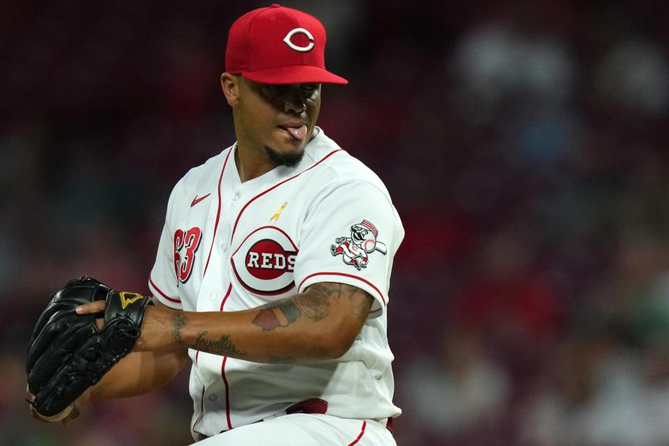 Cincinnati Reds starting pitcher Fernando Cruz (63) begins a delivery during the sixth inning of a baseball game against the Colorado Rockies, Friday, Sept. 2, 2022, at Great American Ball Park in Cincinnati. 