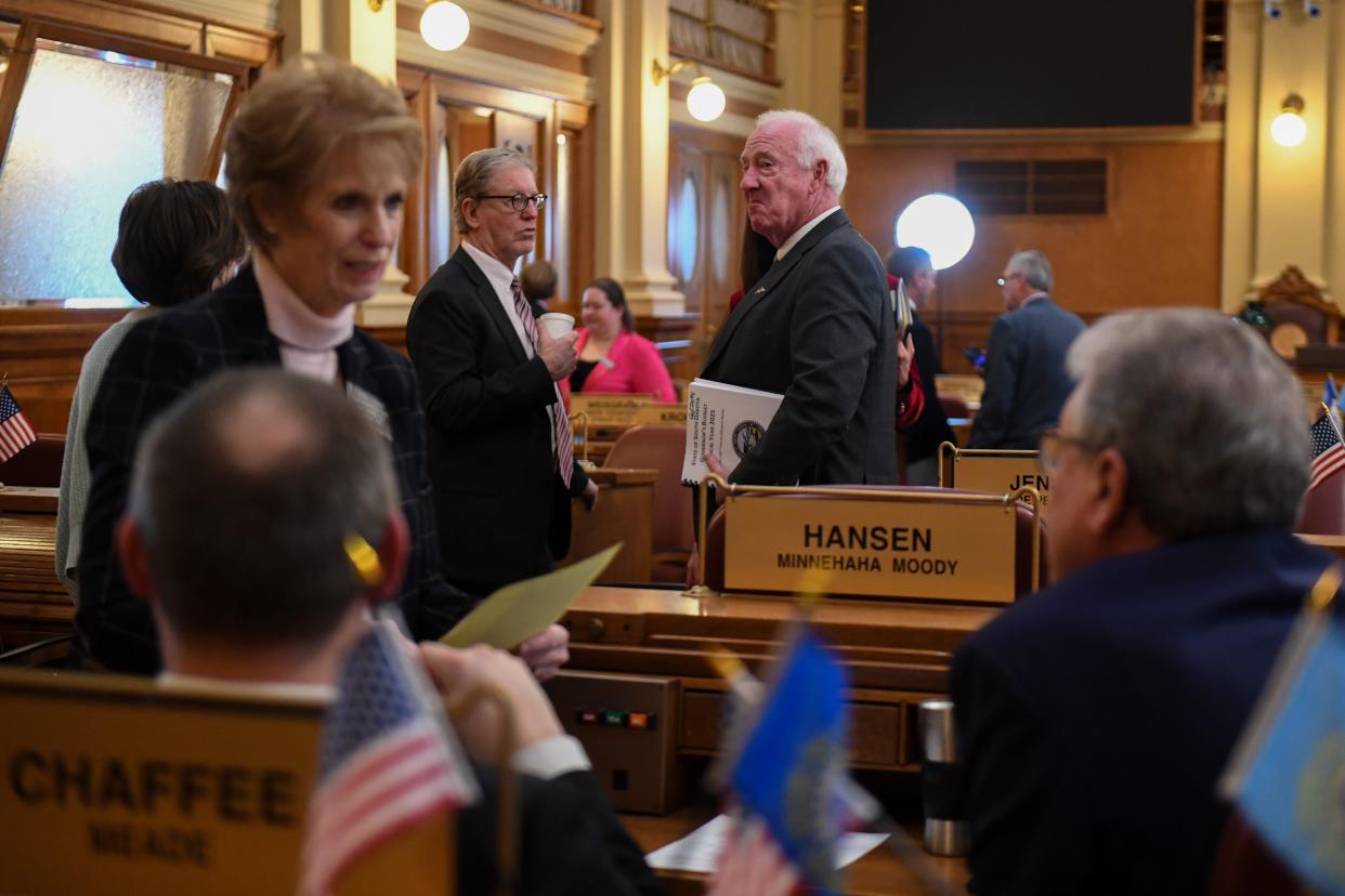 Legislators talk with one another after the annual budget address on Tuesday, Dec. 5, 2023 at the South Dakota State Capitol in Pierre.