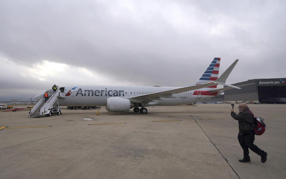 An American Airlines Boeing 737 Max jet plane is prepared for to fly from Dallas Fort Worth airport in Grapevine, Texas, Wednesday, Dec. 2, 2020. American Airlines took its long-grounded Boeing 737 Max jets out of storage, updating key flight-control software, and flying the planes in preparation for the first flights with paying passengers later this month. (AP Photo/LM Otero)