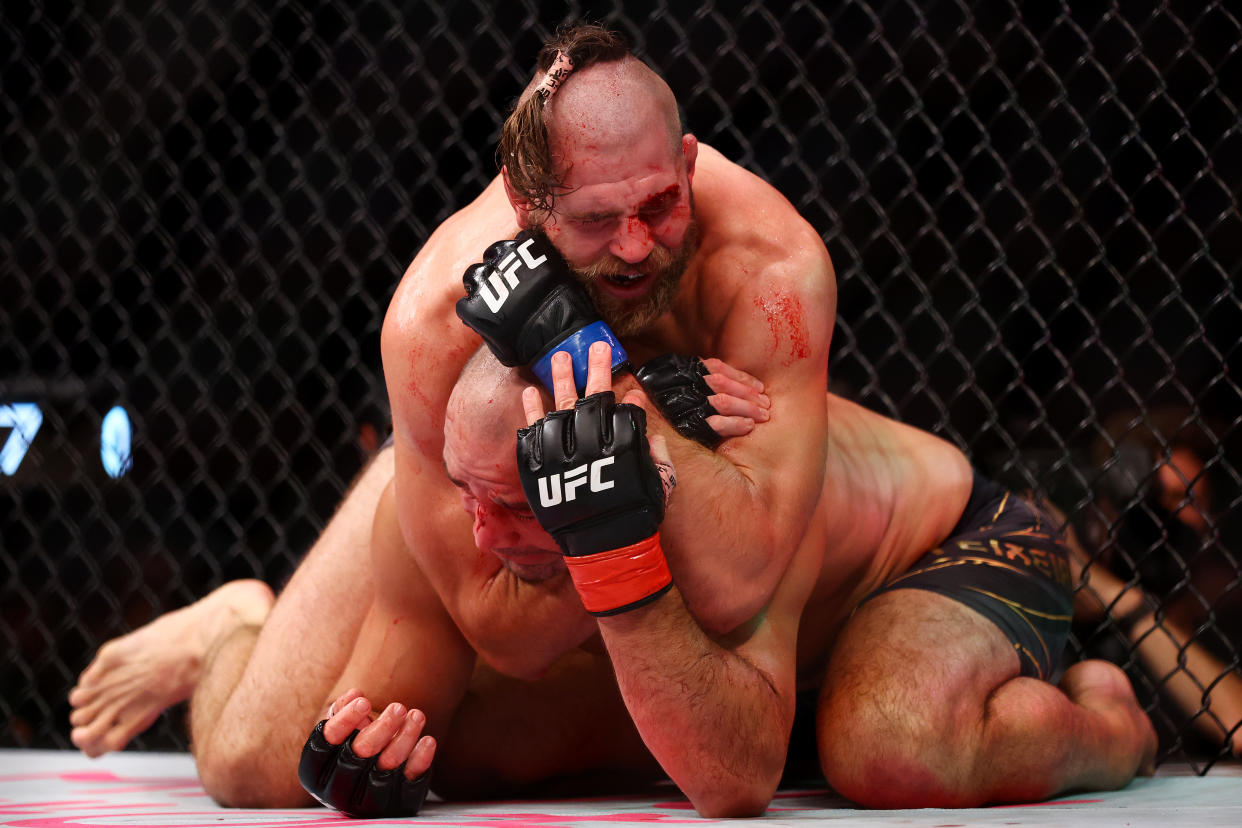 SINGAPORE, SINGAPORE - JUNE 12: Jiri Prochazka of the Czech Republic submits Glover Teixeira of Brazil in the fifth round of their light heavyweight title bout during UFC 275 at Singapore Indoor Stadium on June 12, 2022 in Singapore. (Photo by Yong Teck Lim/Getty Images)