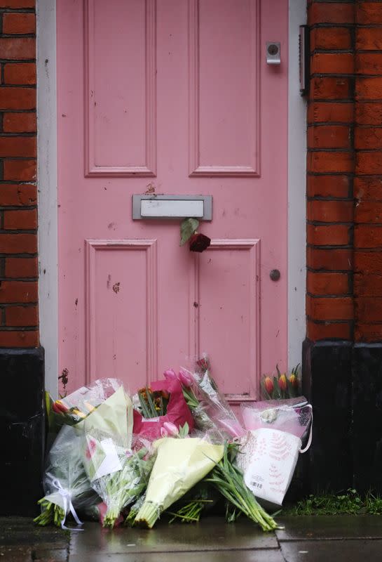 Flowers lie outside British television presenter Caroline Flack's old house in Islington, London