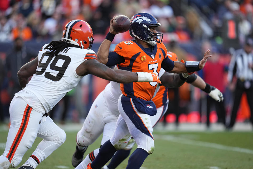 Denver Broncos quarterback Russell Wilson (3) throws under pressure from Cleveland Browns defensive end Za'Darius Smith (99) during the first half of an NFL football game on Sunday, Nov. 26, 2023, in Denver. (AP Photo/Jack Dempsey)