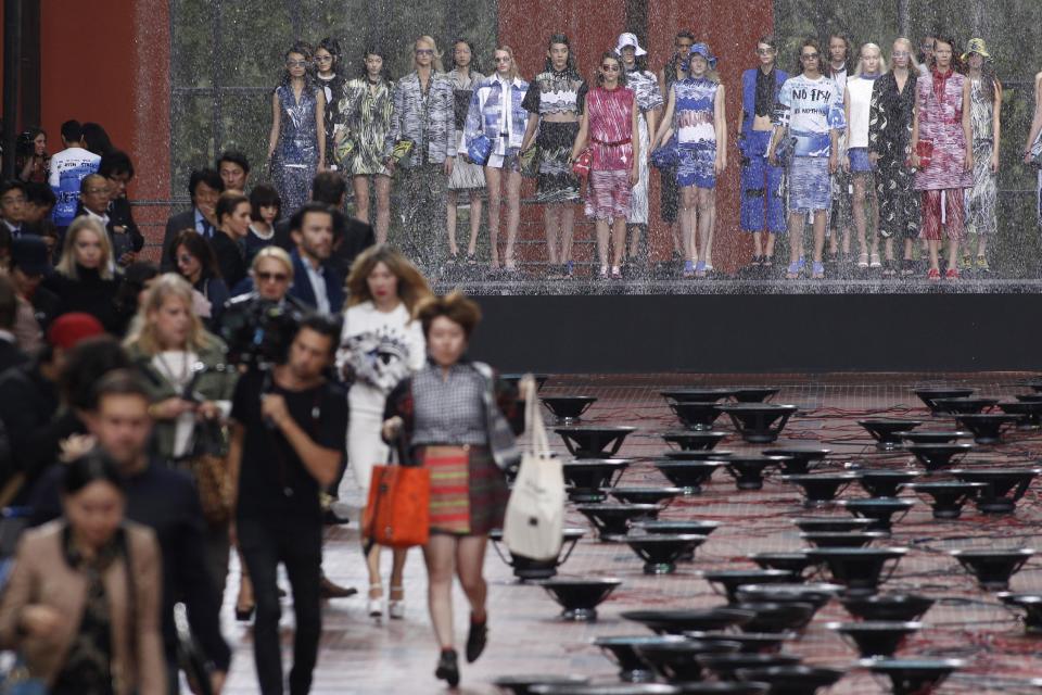 Models present creations at the end of Kenzo's ready-to-wear Spring/Summer 2014 fashion collection, presented Sunday, Sept. 29, 2013 in Paris. (AP Photo/Thibault Camus)