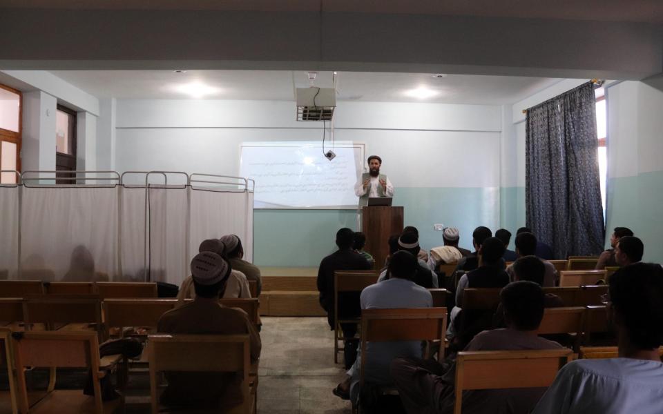 Afghan students seperated by a partition attend a class at Mirwais Neeka University in Kandahar, Afghanistan - STRINGER/EPA-EFE/Shutterstock 