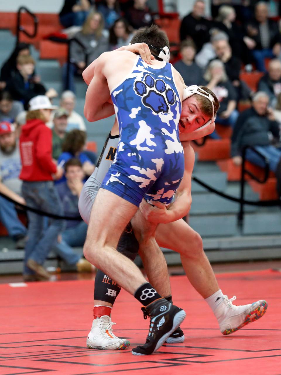 New Lexington's Hunter Rose picks up Washington Court House's Mack Parsley during the finals at 165 pounds at the Division II district tournament on Saturday at Steubenville High School. Rose won, 7-5, to earn a No. 1 seed at next weekend's state tournament.