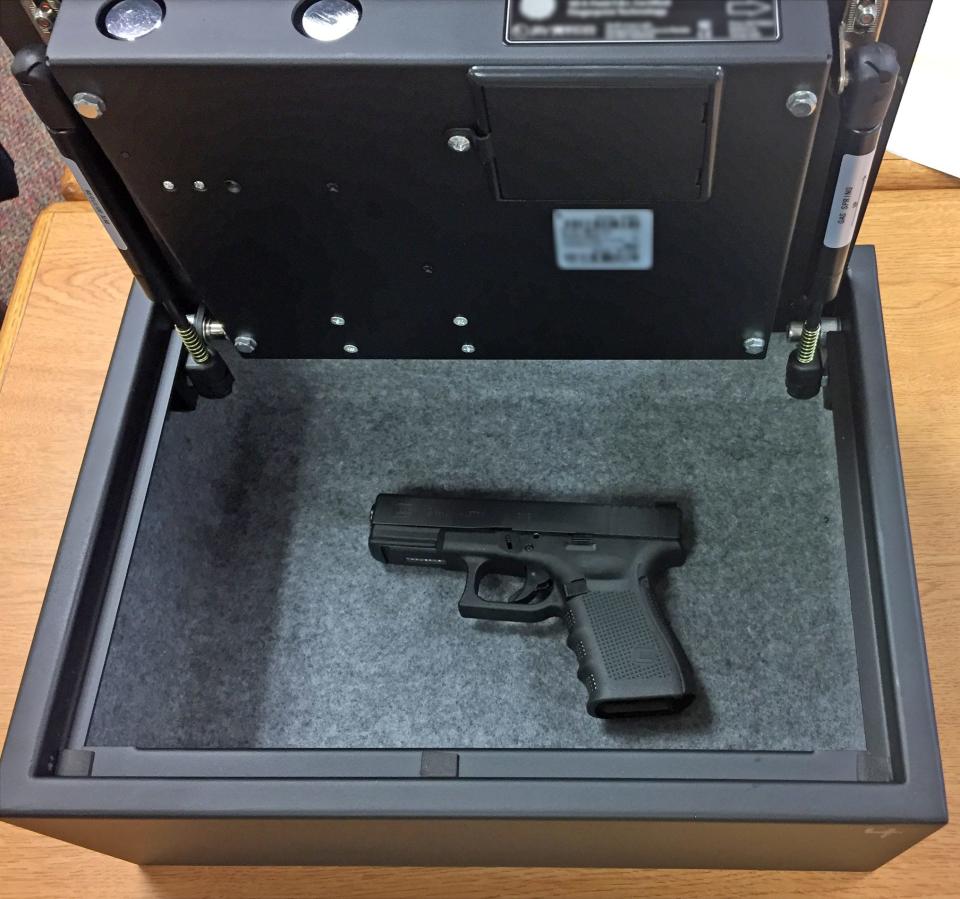 A gun sits in a biometric safe in a Jay County school where members of an 'armed response team' can access the weapon in a school-shooter incident. The small school district established teams made up of staff volunteers four years ago. The safes are strategically hidden around school buildings.