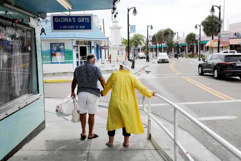 Pedestrians in Florida before Storm Elsa arrives
