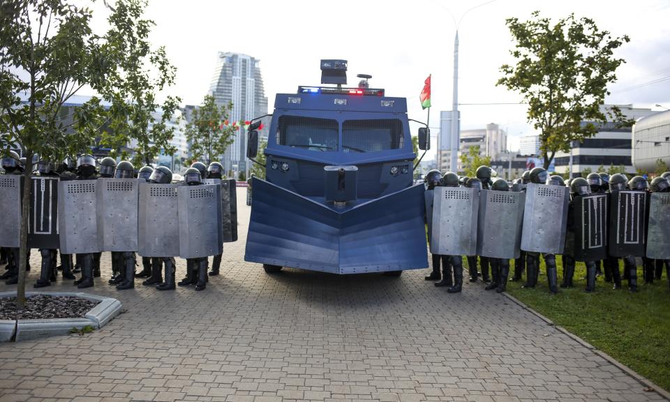 Riot police with a water cannon, block Belarusian opposition supporters during a rally protesting the official presidential election results in Minsk, Belarus, Sunday, Sept. 13, 2020. More than 100,000 demonstrators calling for the authoritarian president's resignation marched in the Belarusian capital on Sunday as the daily protests that have gripped the nation entered their sixth week. (TUT.by via AP)