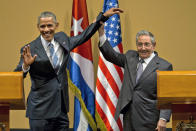 FILE - In this March 21, 2016, file photo, Cuban President Raul Castro, right, lifts up the arm of President Barack Obama at the conclusion of their joint news conference at the Palace of the Revolution in Havana, Cuba. Obama's handling of the Syrian civil war was widely perceived as a major foreign policy failure. That stood alongside substantial foreign policy wins, including the Iran nuclear deal, which infuriated traditional U.S. allies Israel and Saudi Arabia, and normalization of relations with Cuba, both of which Trump made a priority to rip apart. (AP Photo/Ramon Espinosa, File)