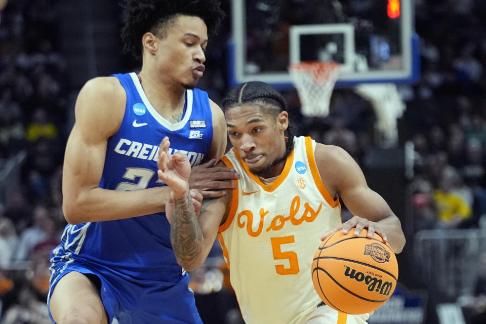Tennessee guard Zakai Zeigler (5) drives as Creighton guard Trey Alexander defends during the first half of a Sweet 16 college basketball game in the NCAA Tournament, Friday, March 29, 2024, in Detroit. (AP Photo/Paul Sancya)