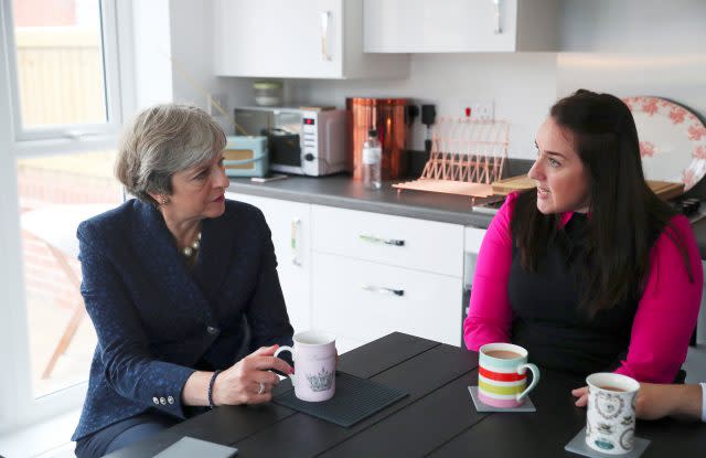 Prime Minister Theresa May visits the home of Rebecca Coulton, who bought a starter home using the Government's Help to Buy scheme, in Walkden, Salford, during the Conservative Party conference in Manchester (Hannah McKay/PA)