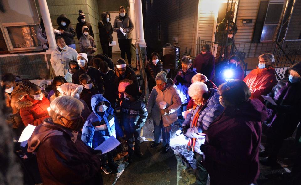 Family members of Rhonda Glover, left, join sisters religious and others in a "Take Back the Site Vigil, Reclaiming the Site for Nonviolence" gathering on Dec. 9, 2021, in the 600 block of East 13th Street in Erie. Glover, the mother of six children, was shot and killed on Nov. 17, 2021, while sitting in a car near there. Two men were convicted of murdering her and have been sentenced to state prison.