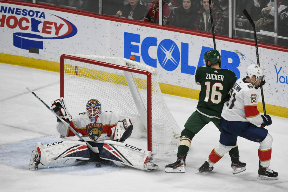 Florida Panthers goalie Sergei Bobrovsky, left, stops a shot by Minnesota Wild winger Jason Zucker (16) as Panthers defenseman Riley Stillman pushes Zucker past the goal during the first period of an NHL hockey game Monday, Jan. 20, 2020, in St. Paul, Minn. (AP Photo/Craig Lassig)