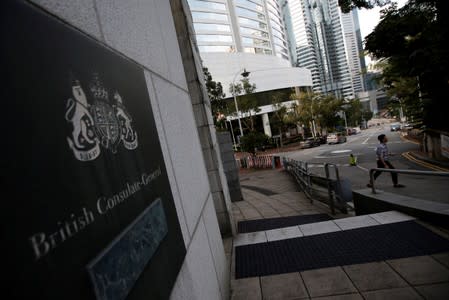 A man crosses a road outside the British Cosulate-general office in Hong Kong