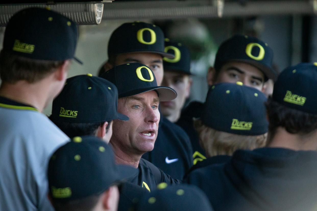 Oregon head coach Mark Wasikowski talks to his team in the dugout as the Oregon Ducks host Lafayette Saturday, Feb. 24, 2024, at PK Park in Eugene, Ore.