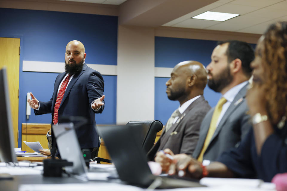 Attorney Scott Grubman, who is defending Kenneth Chesebro, left, argues before Fulton County Superior Court Judge Scott McAfee, not pictured, in Atlanta on Thursday, Sept. 14, 2023. Donald Trump will not face trial next month in Georgia after McAfee ruled Thursday that the former president and 16 others accused of illegally trying to overturn the results of the 2020 election will be tried separately from two lawyers in the case. Lawyers Sidney Powell and Kenneth Chesebro had filed demands for a speedy trial, and McAfee set their trial to begin Oct. 23. (Miguel Martinez/Atlanta Journal-Constitution via AP, Pool)