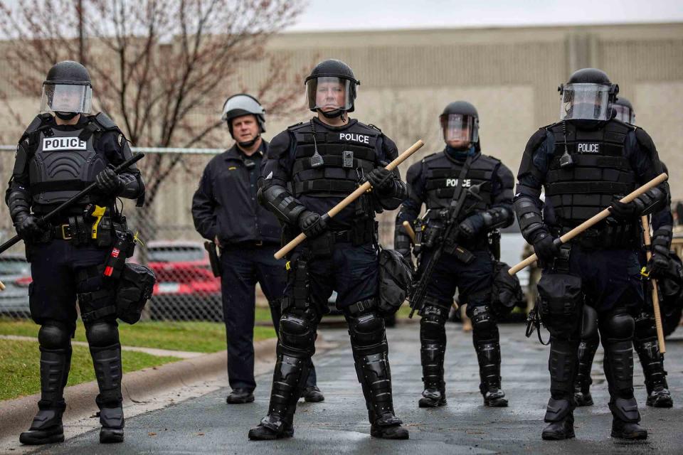 Minnesota Police officers stand guard on April 12, 2021, outside the Brooklyn Center Police Station, after a police officer shot and killed Daunte Wright during a traffic stop near Minneapolis<span class="copyright">Kerem Yucel—AFP/Getty Images</span>