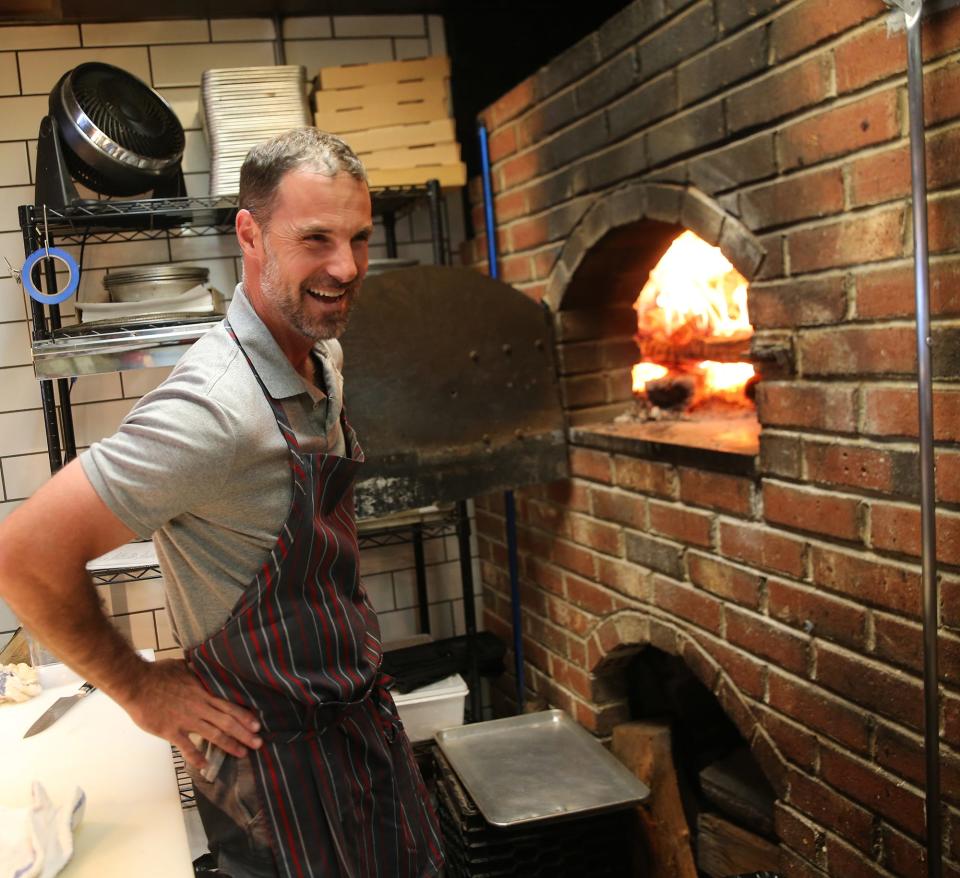 Gregg Sessler works in the Odd Fellows Tavern kitchen with the popular wood-fired oven, which is used for pizzas, nachos, wings and more.
