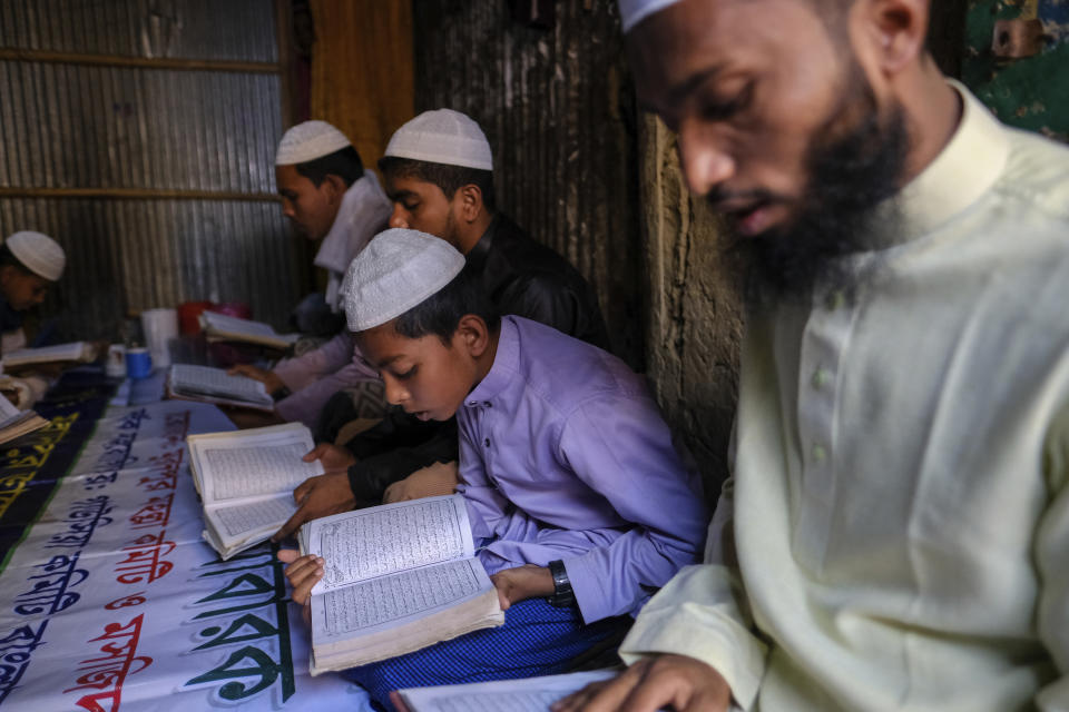 Rohingya refugees read the Quran at the Nayapara refugee camp in the Cox's Bazar district of Bangladesh, on March 10, 2023. (AP Photo/Mahmud Hossain Opu)