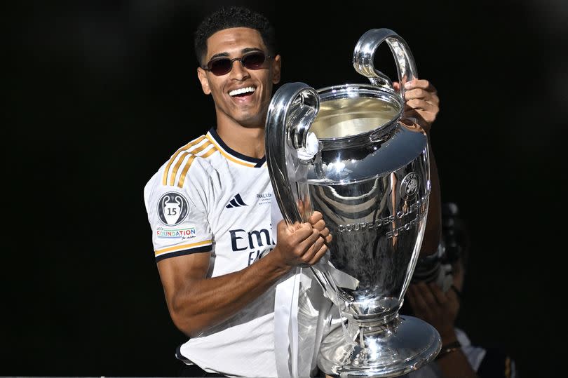 MADRID, SPAIN - JUNE 02: Jude Bellingham of Real Madrid raises the trophy during Real Madrid UEFA Champions League Trophy Parade celebrating their victory of 15th Champions League at Cibeles Square in Madrid, Spain on June 02, 2024.