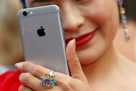 A guest uses her Iphone to take pictures in Cannes, France, May 12, 2016.REUTERS/Regis Duvignau/File Photo