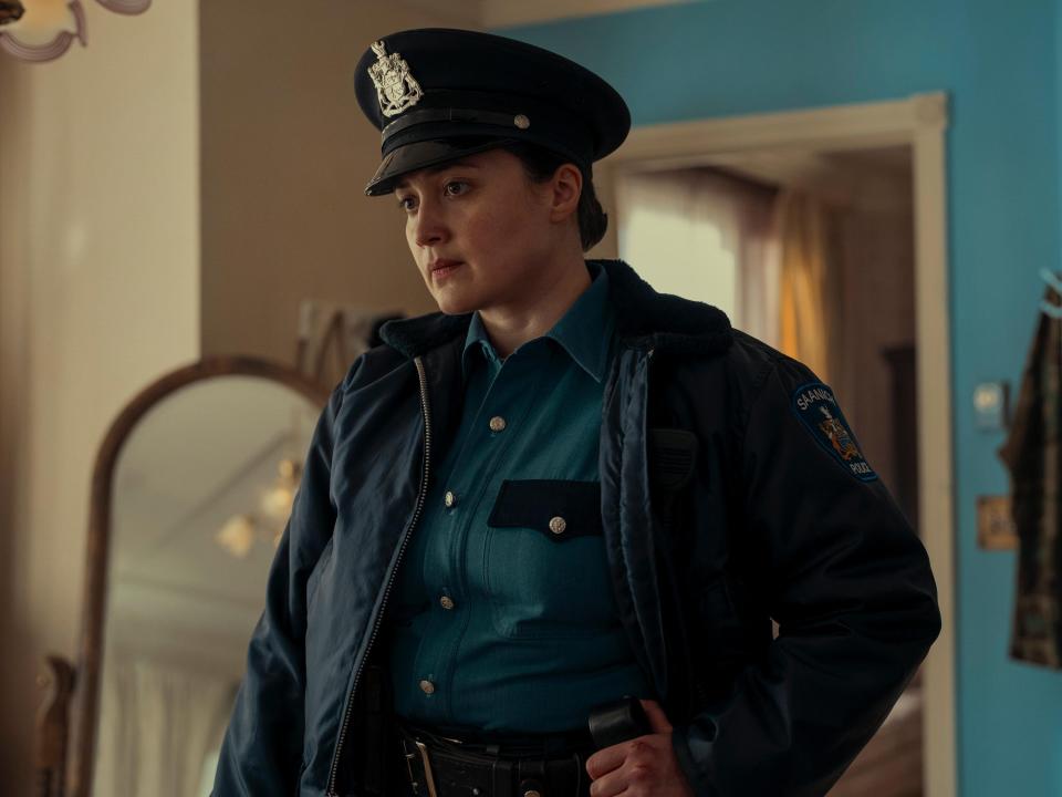 Lily Gladstone wears a police uniform and cap in an image from the Hulu series "Under the Bridge."