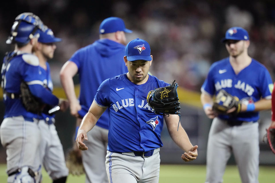 Toronto Blue Jays starting pitcher Yusei Kikuchi, of Japan, flips his glove in the air as he walks off the field after being replaced during the fifth inning of a baseball game against the Arizona Diamondbacks, Sunday, July 14, 2024, in Phoenix. (AP Photo/Ross D. Franklin)