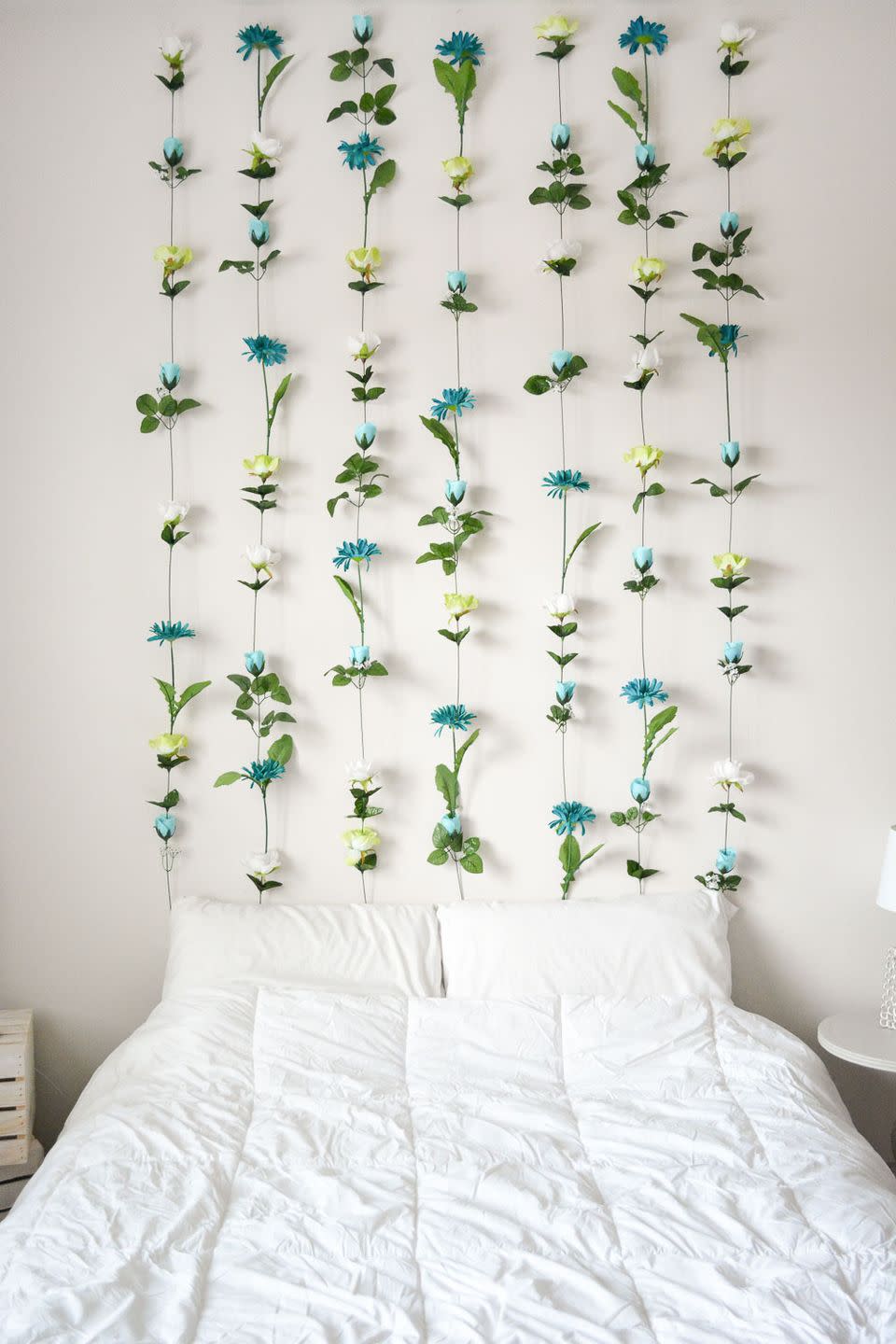 <p>Who needs a <a href="https://www.housebeautiful.com/room-decorating/bedrooms/g717/headboard-designs/" rel="nofollow noopener" target="_blank" data-ylk="slk:headboard;elm:context_link;itc:0;sec:content-canvas" class="link ">headboard</a> when you can have a full-on wall of flowers? Total boho goals. Get the tutorial at <a href="http://sweetteal.com/2016/07/diy-flower-wall/" rel="nofollow noopener" target="_blank" data-ylk="slk:Sweet Teal;elm:context_link;itc:0;sec:content-canvas" class="link ">Sweet Teal</a>.</p>