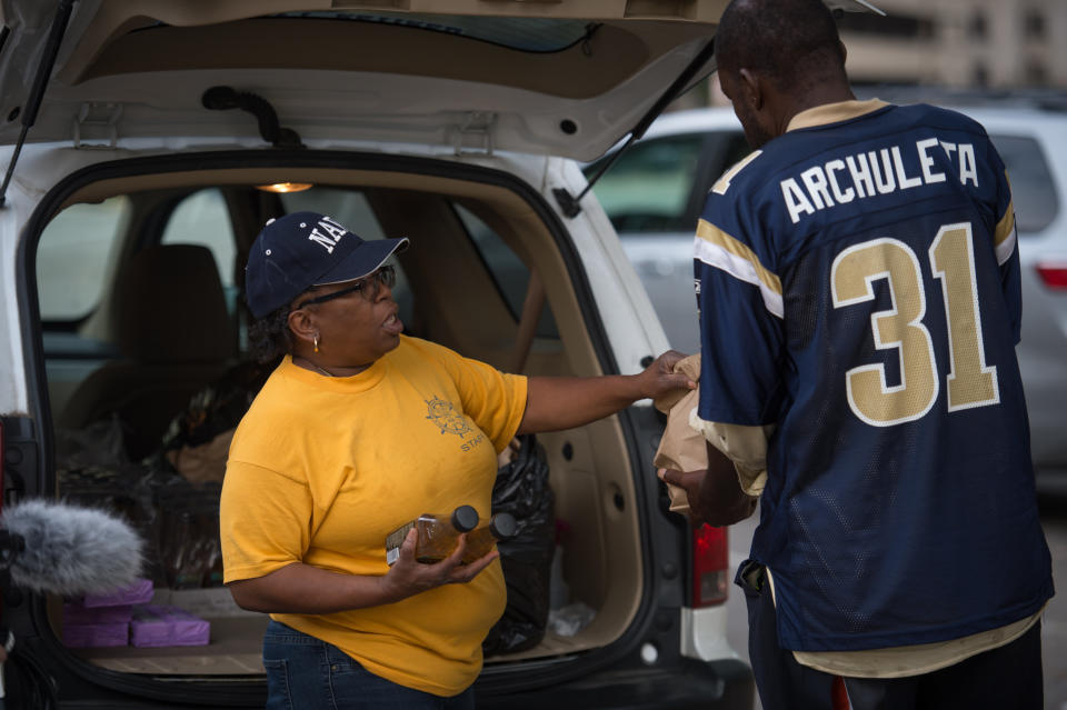 Kat "Mama Kat" Daniels passes out dinner to homeless citizens.