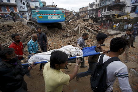 ATTENTION - VISUAL COVERAGE OF SCENES OF INJURY OR DEATH Rescue workers carry the body of a victim on a stretcher, after a 7.9 magnitude earthquake hit, in Kathmandu, Nepal April 25, 2015. REUTERS/Navesh Chitrakar