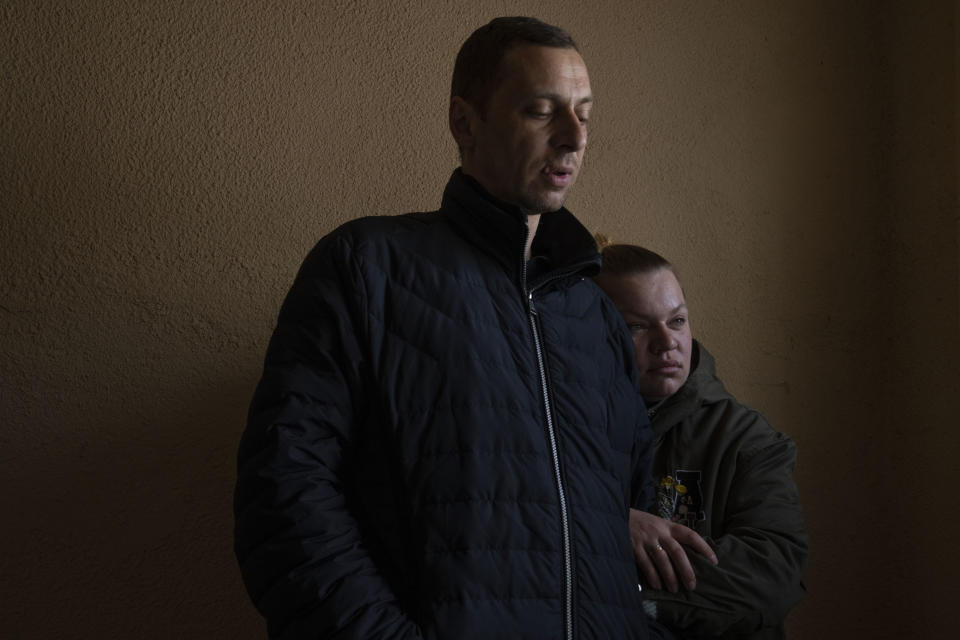 Iryna and Volodymyr, internally displaced from Irpin, lean on each other, near an apartment they took refuge in with four other adults from Irpin, in Lviv, western Ukraine, Sunday, April 3, 2022. Iryna and her husband Volodymyr were trapped for days between Ukrainian and Russian forces and quickly learned to distinguish between incoming and outgoing fire. They took shelter in a basement and whenever the shelling eased, they climbed out to shout to their neighbors to see if they were still alive. (AP Photo/Nariman El-Mofty)