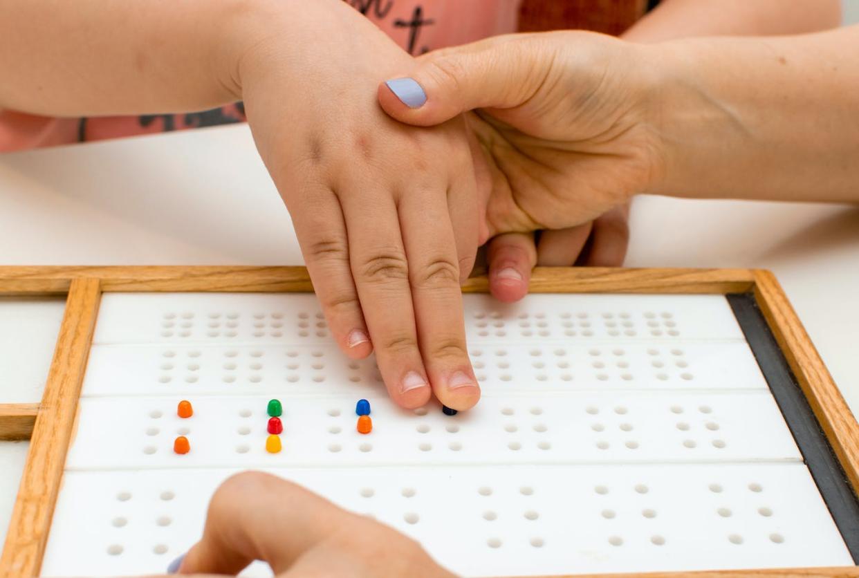 <a href="https://www.shutterstock.com/es/image-photo/hands-close-girl-teacher-braille-board-1996259354" rel="nofollow noopener" target="_blank" data-ylk="slk:PredragLasica/shutterstock;elm:context_link;itc:0;sec:content-canvas" class="link ">PredragLasica/shutterstock</a>