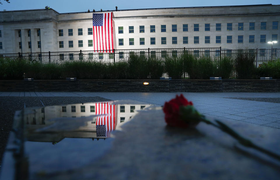 A U.S. flag is unfurled at sunrise on Tuesday, Sept. 11, 2018, at the Pentagon on the 17th anniversary of the Sept. 11, 2001, terrorist attacks. (AP Photo/Pablo Martinez Monsivais)